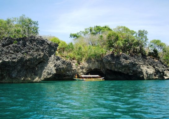 boat in the entrance of Baras Cave